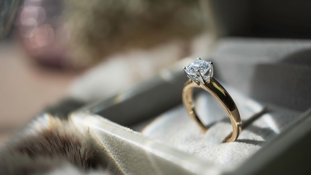 A close up of a diamond ring in a box.