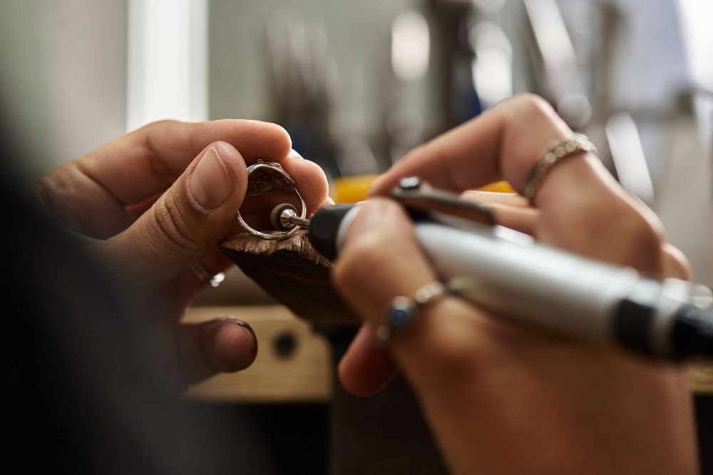 A person is working on a ring with a marker.