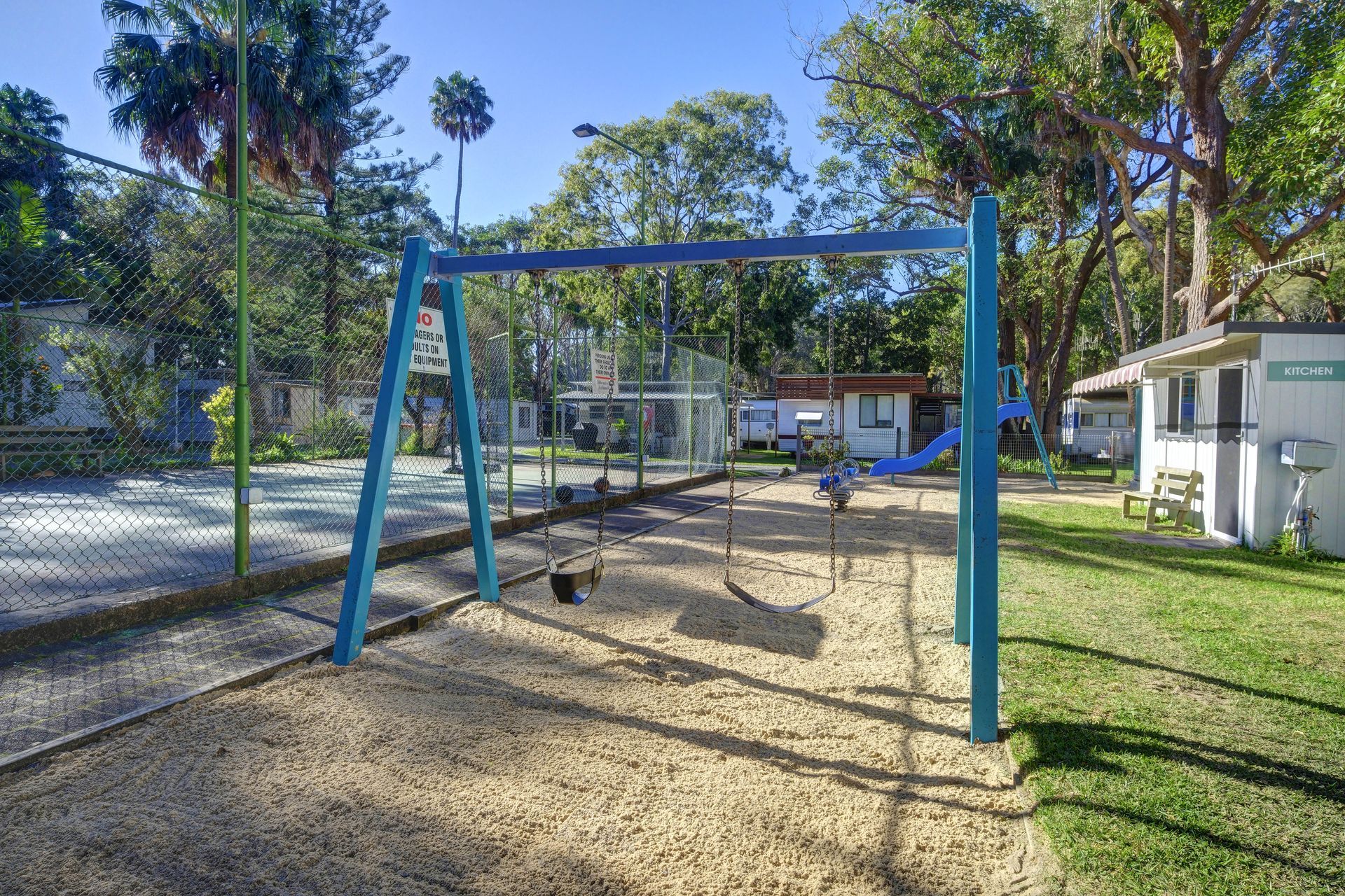 A Playground With A Blue Monkey Bars And A Ladder — Pacific Palms Caravan Park in Elizabeth Beach, NSW