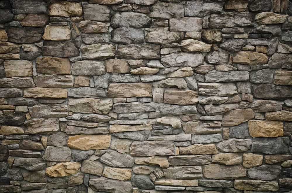 A Close Up Of A Stone Wall Made Of Different Types Of Rocks — Mascrete Pty Ltd In Hermit Park, QLD