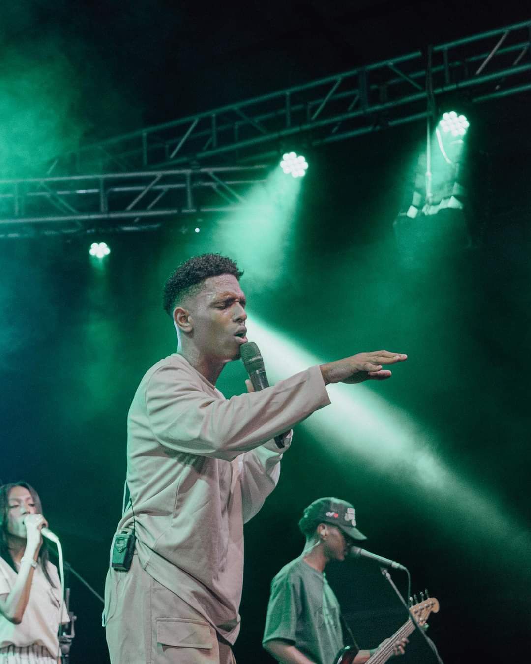 A man singing into a microphone on a stage