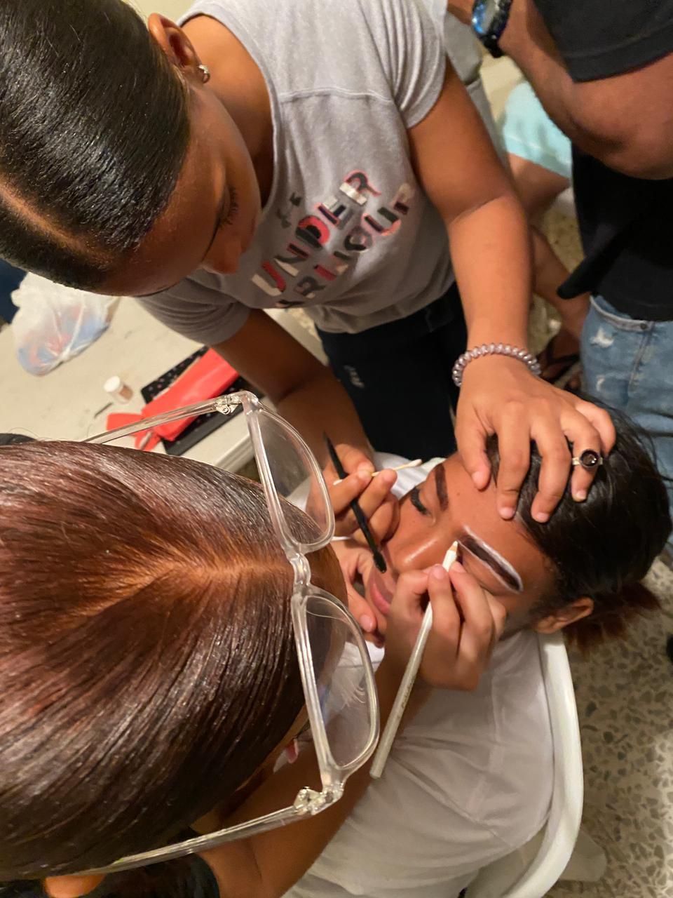 A woman is applying makeup to another woman 's face