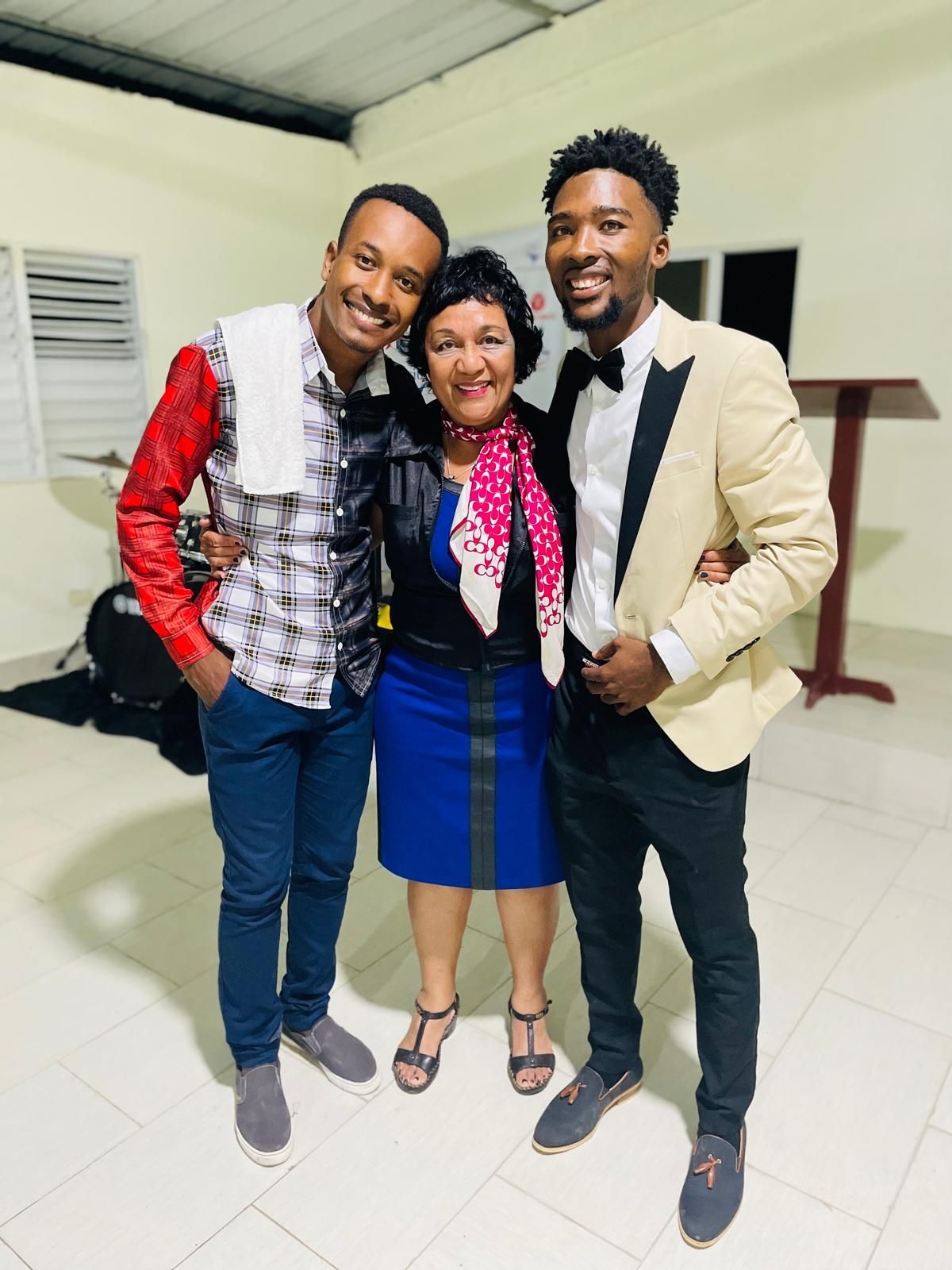 Two men and a woman are posing for a picture together