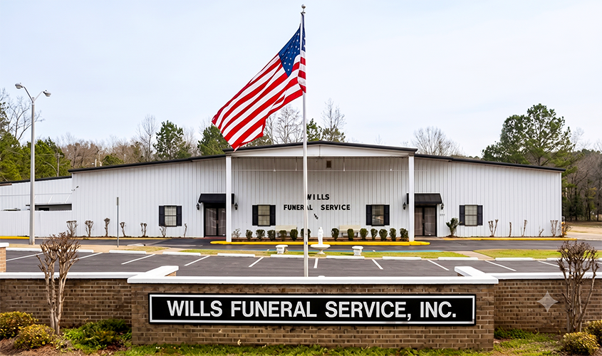 Wills Funeral Service building with an American flag and sign in front