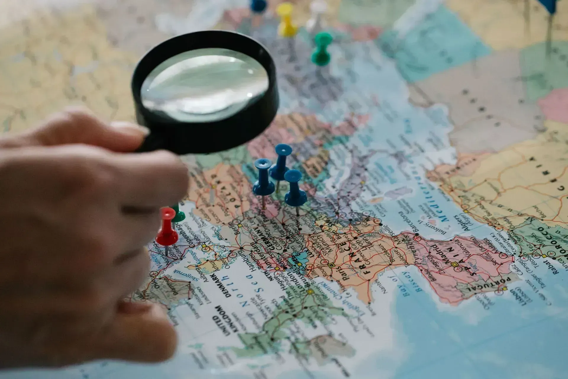 Red location pin on a folded colorful map