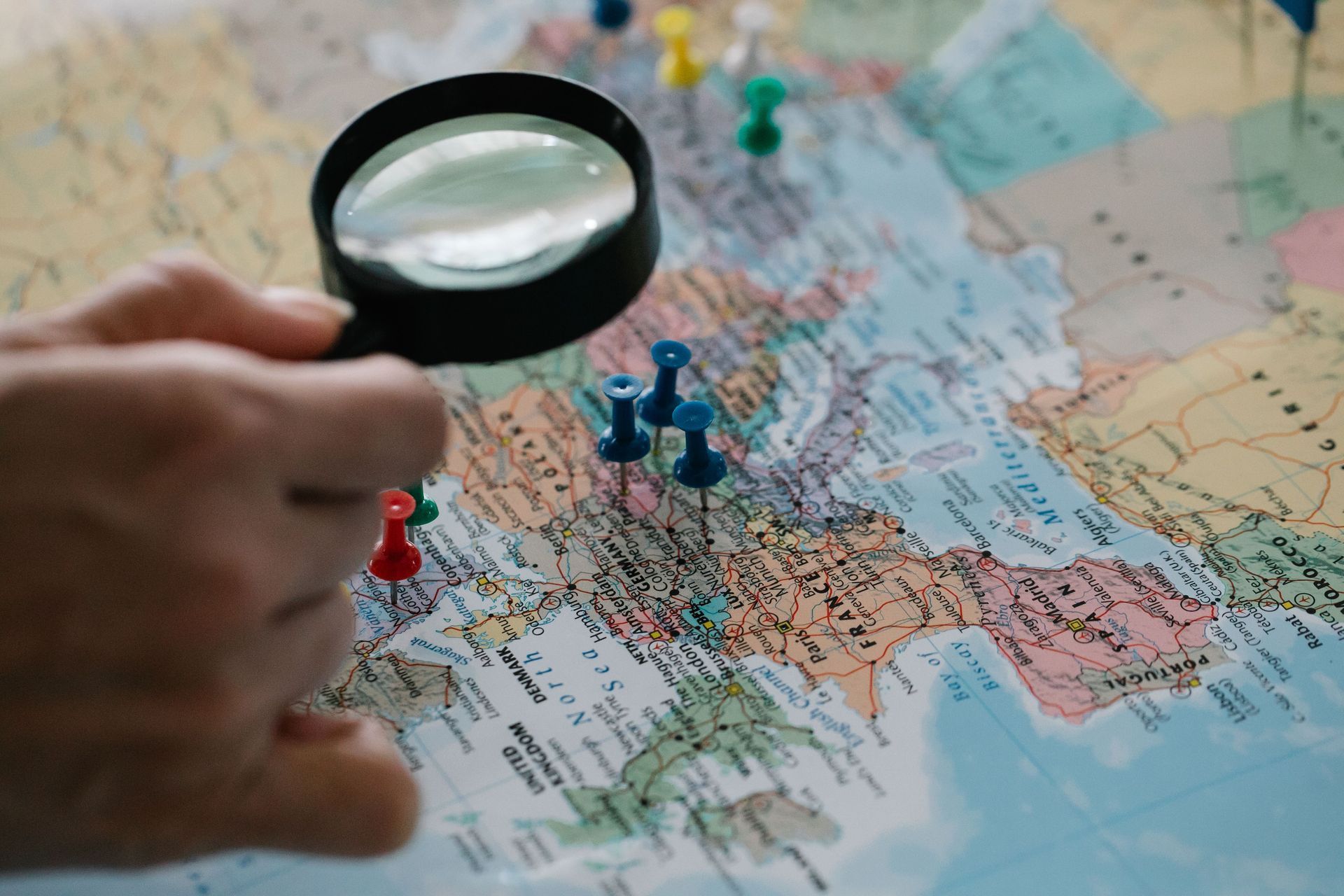 Red location pin on a folded colorful map