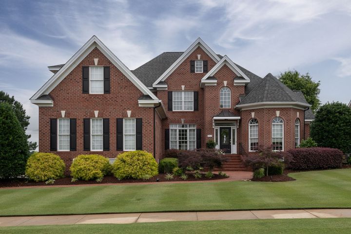 House with a Sold sign in the front yard
