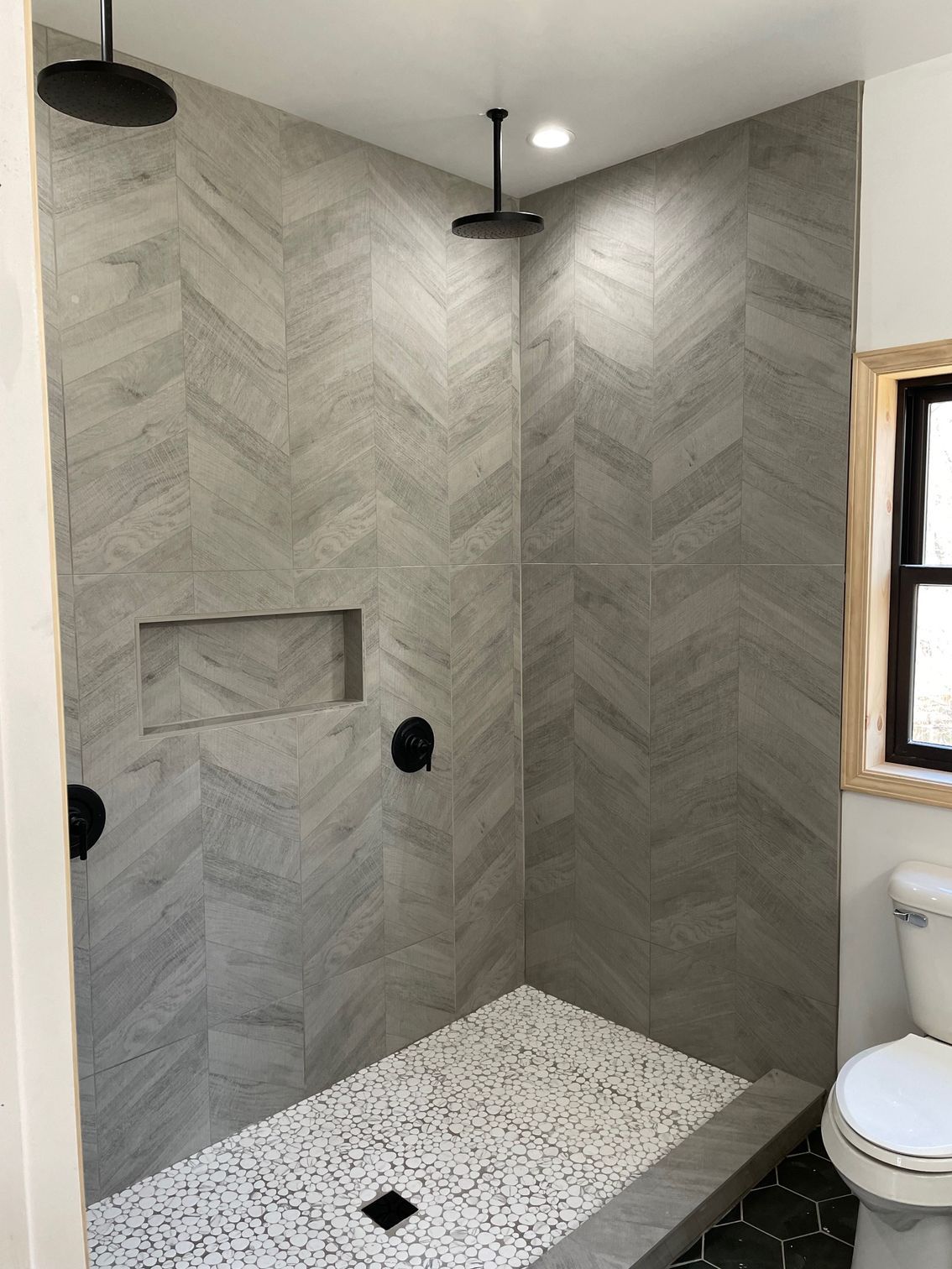 A bathroom with a walk in shower and a toilet.