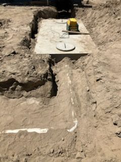 Trench with a concrete septic tank, installation site.