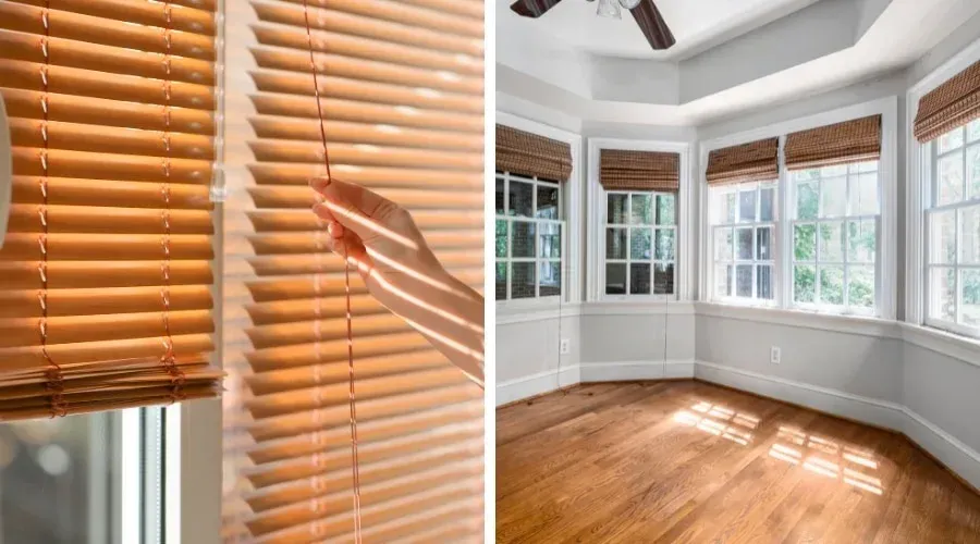 Hand adjusting white blinds beside a bright bay window with wooden blinds and hardwood floor