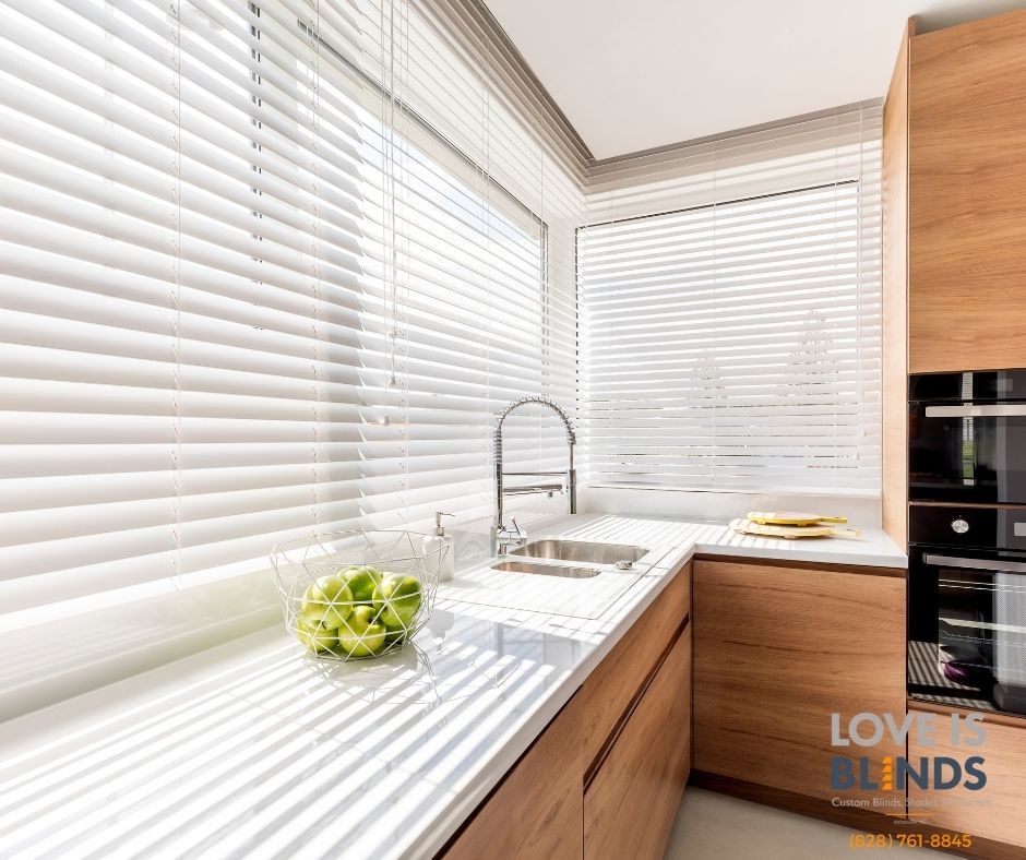 Bright white kitchen with striped blinds, wooden cabinets, sink, and green flowers on the counter