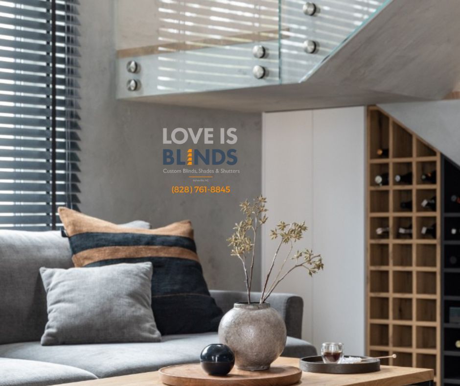 Modern living room with gray sofa, wood accents, and wall art reading