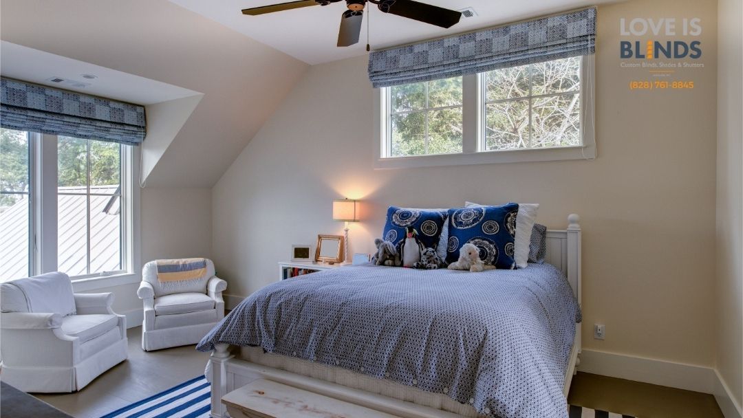 Bright bedroom with a bed, white armchairs, large windows, gray rug, and ceiling fan