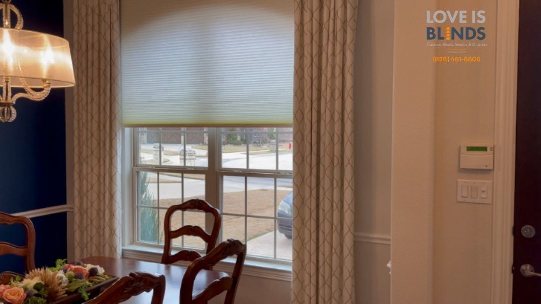 Dining room with window, chairs, and a “Love is Blind” wall sign.