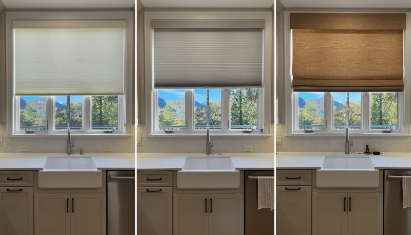 Three kitchen windows with shades at different heights above a sink and countertop.