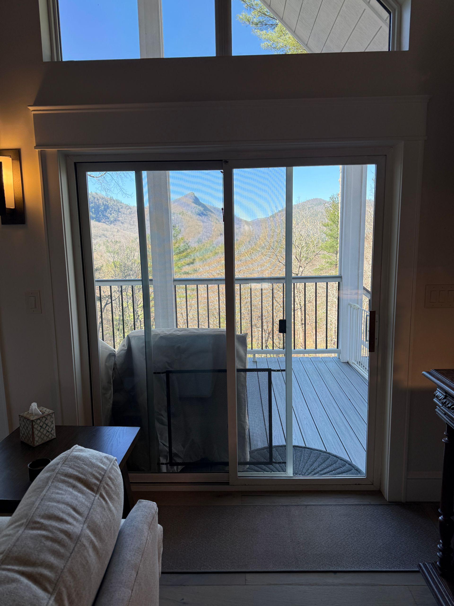 Living room with sliding glass doors opening to a balcony and mountain view