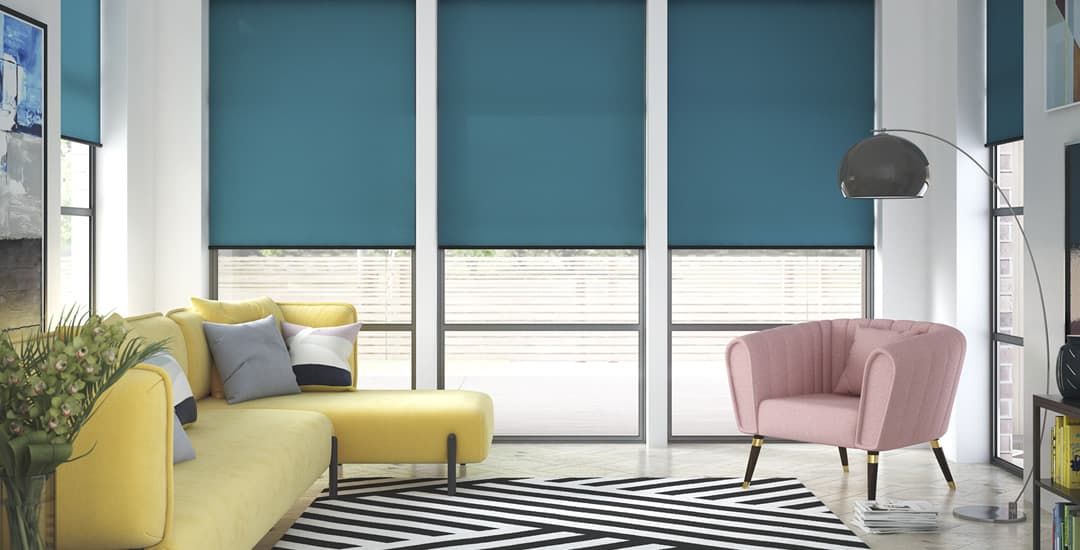 Modern living room with yellow sofa, pink chair, blue blinds, and black-and-white rug