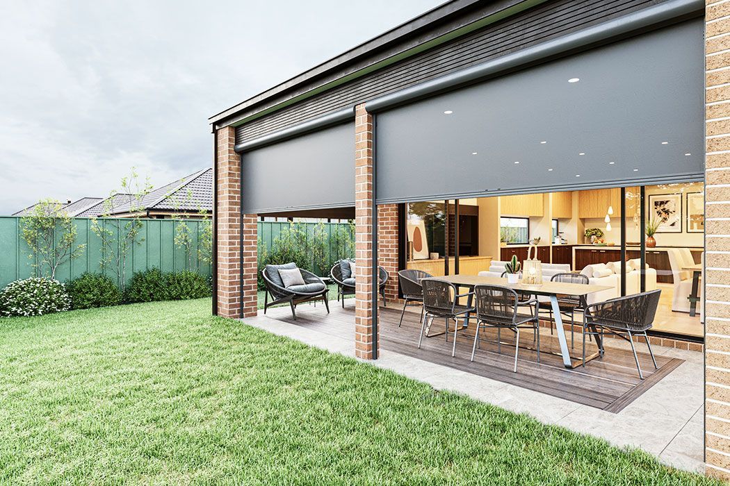 Modern patio and grassy backyard with outdoor dining area under a covered veranda