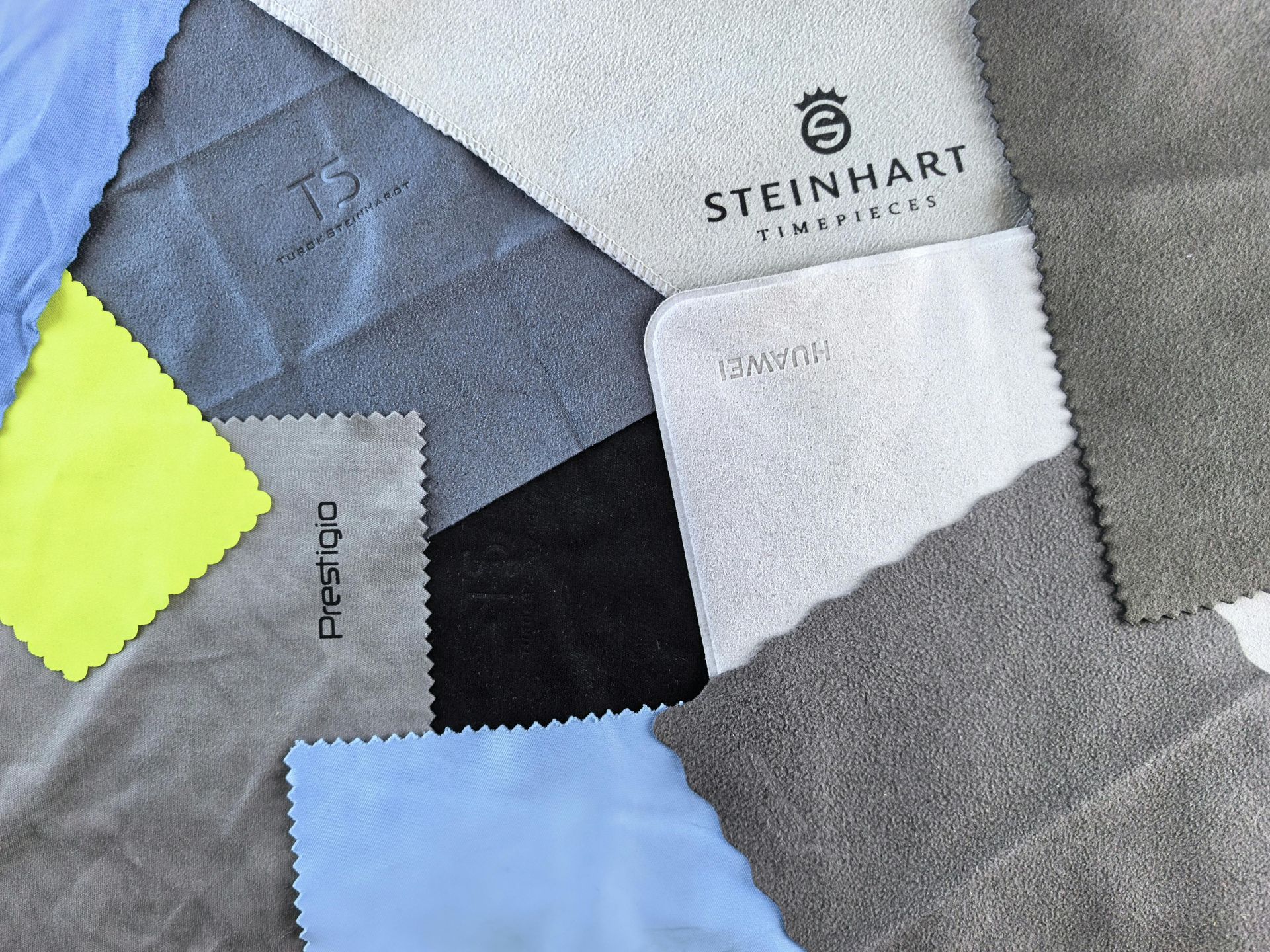 Color swatches arranged in a patchwork, labeled Steinhart and featuring gray, blue, white, and neon yellow fabric samples