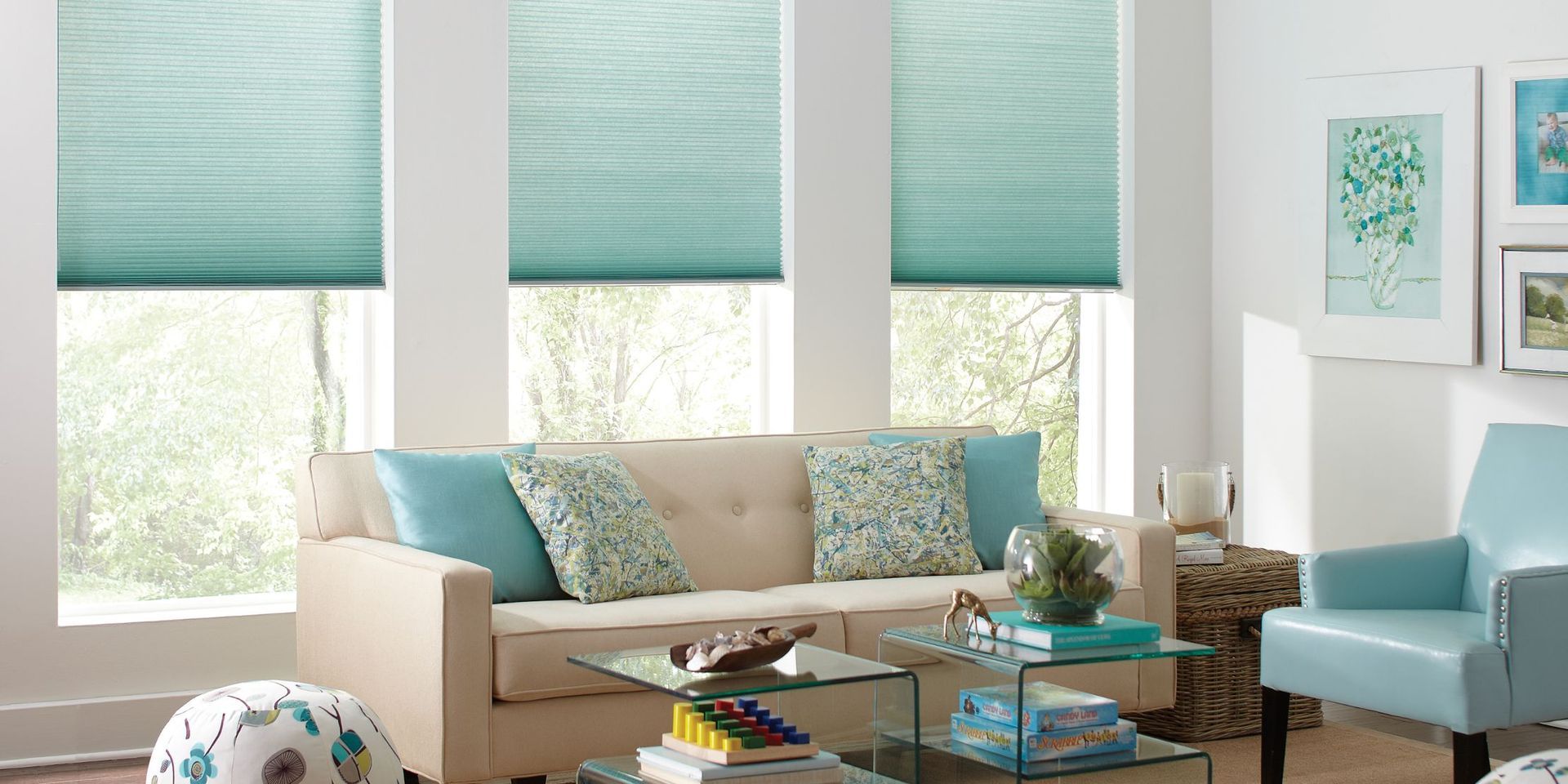 Bright living room with teal blinds, beige sofa, and blue accent chair by the window