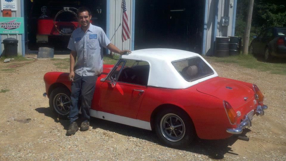 Auto Technician Standing Beside A Red Classic Convertible | Yoder's Auto Repair