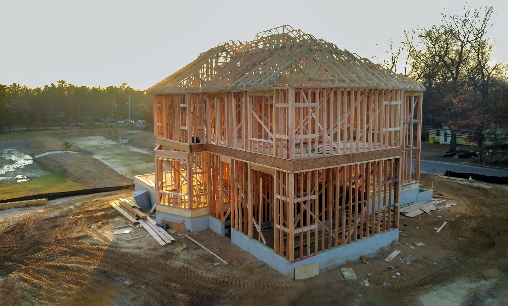 An aerial view of a house under construction in the middle of a field.