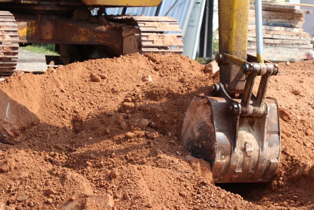 Bulldozer Is Digging A Hole In The Ground — Ian Brown Sand Supplies and Tipper Hire In Laurieton, NSW