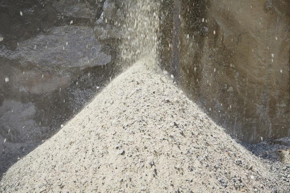 A Pile Of Sand Is Sitting On Top Of A Table — Ian Brown Sand Supplies and Tipper Hire In Port Macquarie, NSW