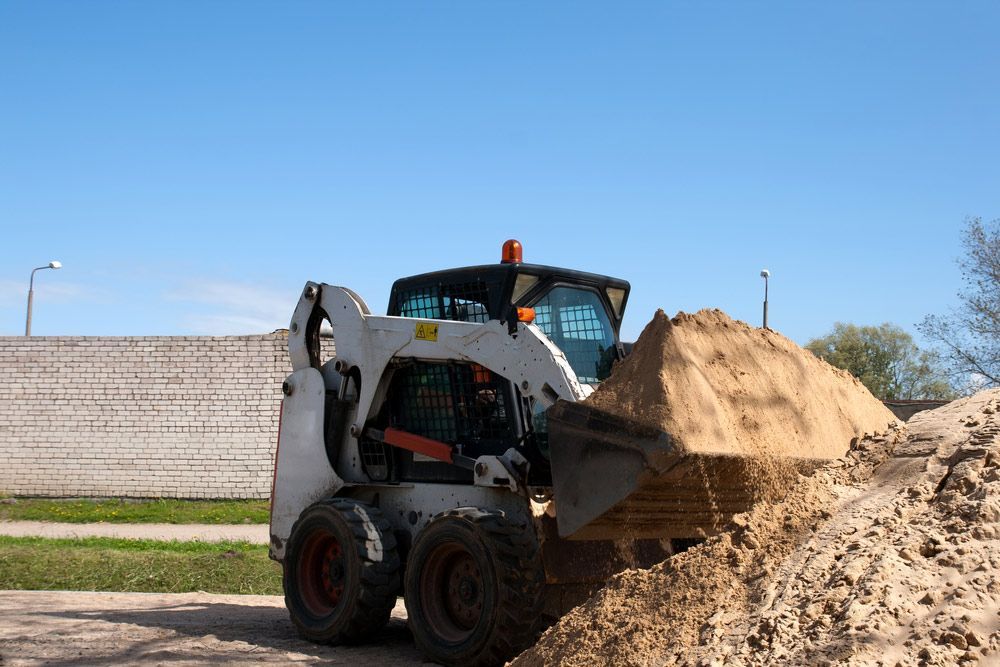 A Bulldozer Is Loading Sand Into A Bucket — Ian Brown Sand Supplies and Tipper Hire In Port Macquarie, NSW