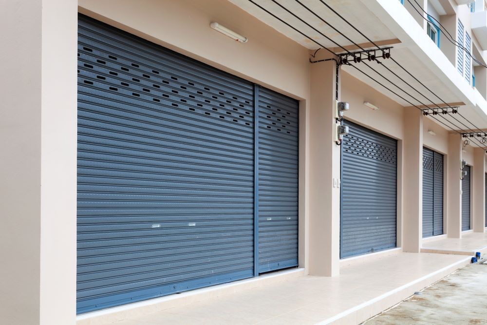 A Building With a Row of Roller Shutters on the Side of It — Kingaroy Self Storage Sheds in Kingaroy, QLD