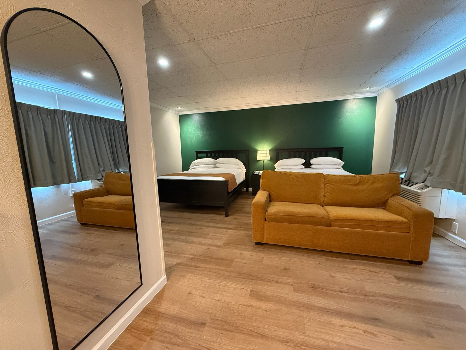 A hotel room with a microwave and a sink
