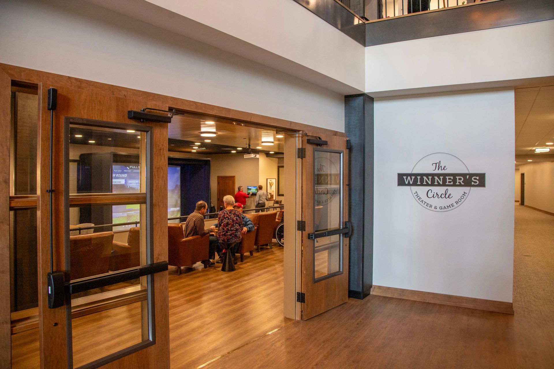 People gather in a room labeled