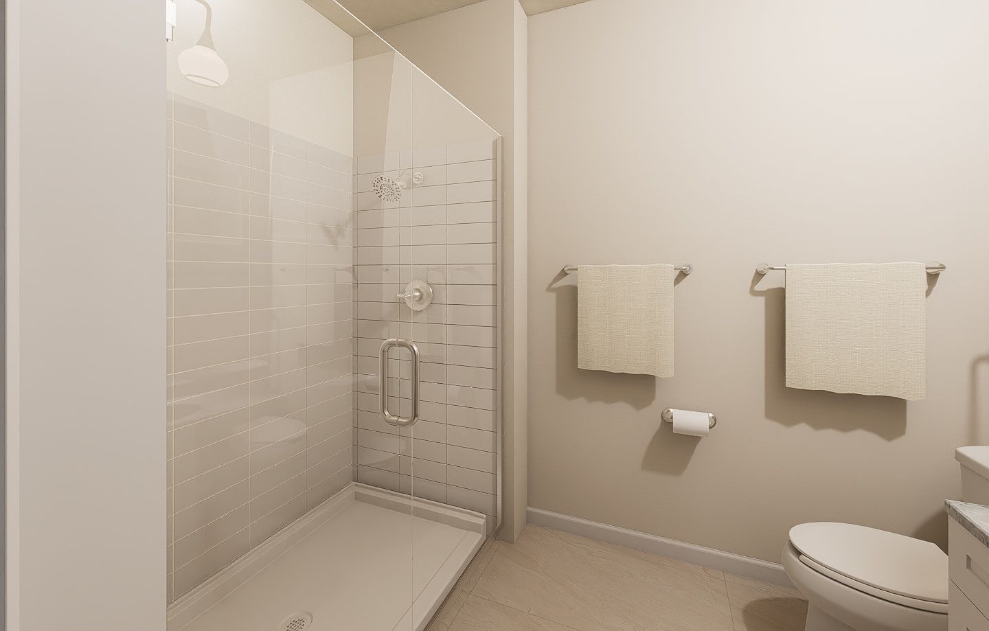 A modern bathroom with a glass-enclosed shower, two towel racks on a beige wall, and a toilet.