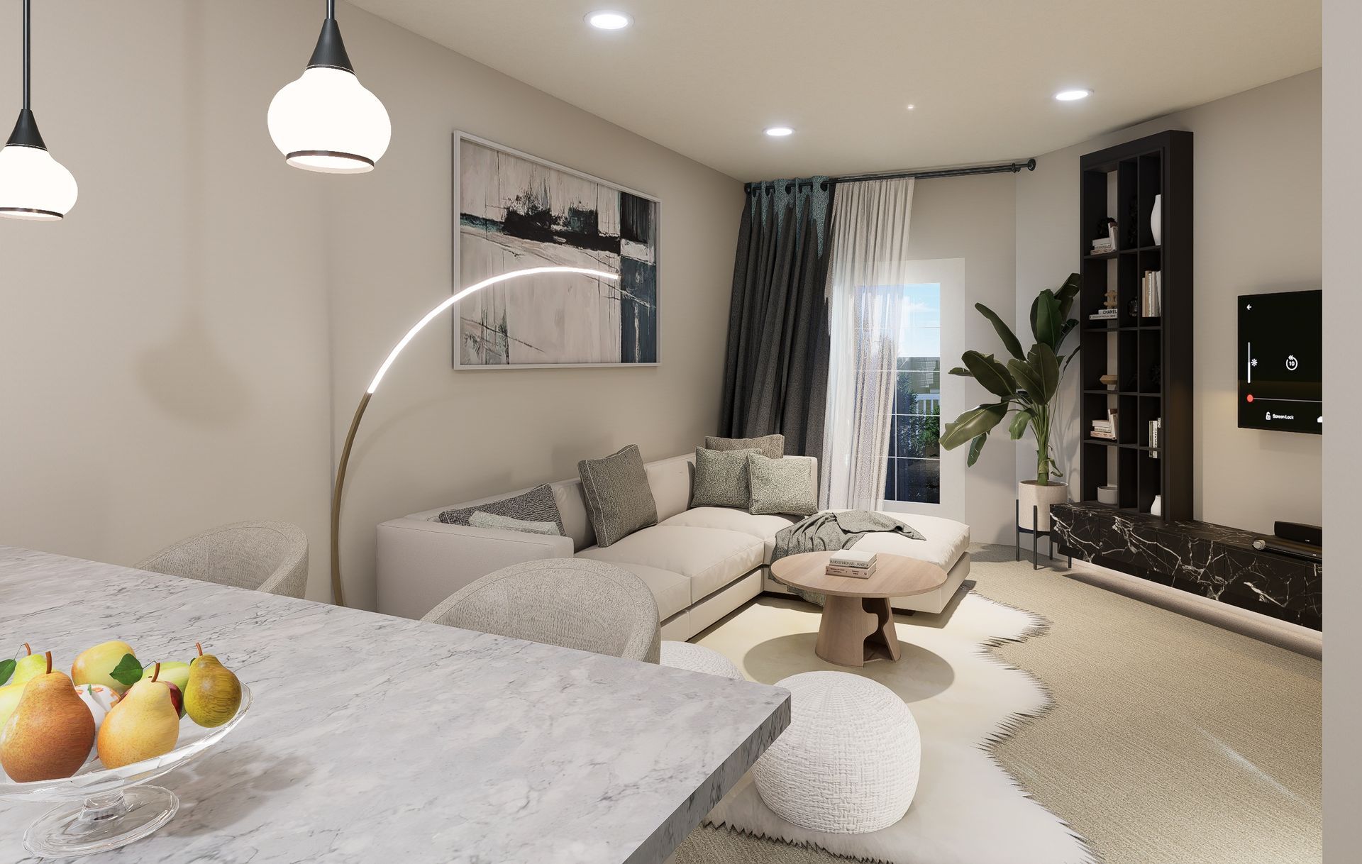 A modern, neutral-toned living room with a white sofa, round coffee table, black shelving unit, and a kitchen island.