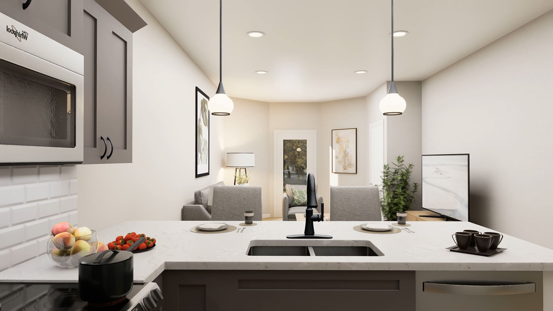 A kitchen island with a double sink faces a living area with gray sofas, wall art, and a television in a modern room.