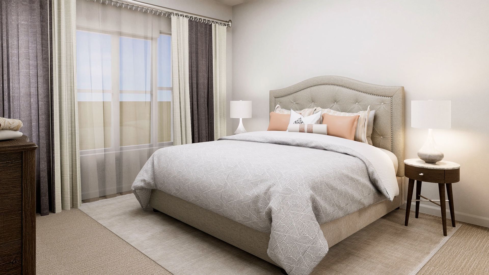 A neutrally toned bedroom featuring a tufted headboard bed, patterned bedding, two nightstands, and layered curtains.