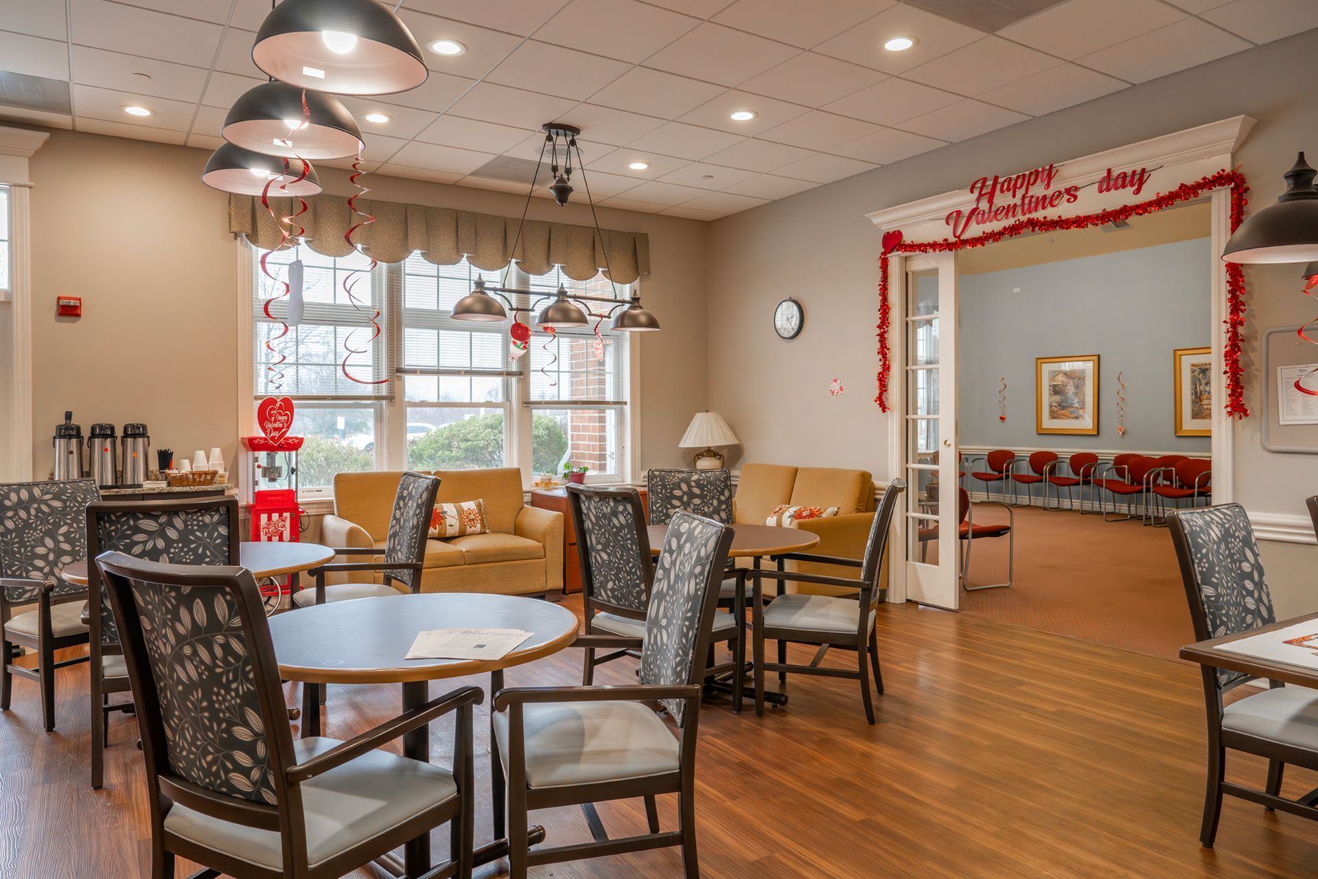 A common area with tables, chairs, and couches, featuring