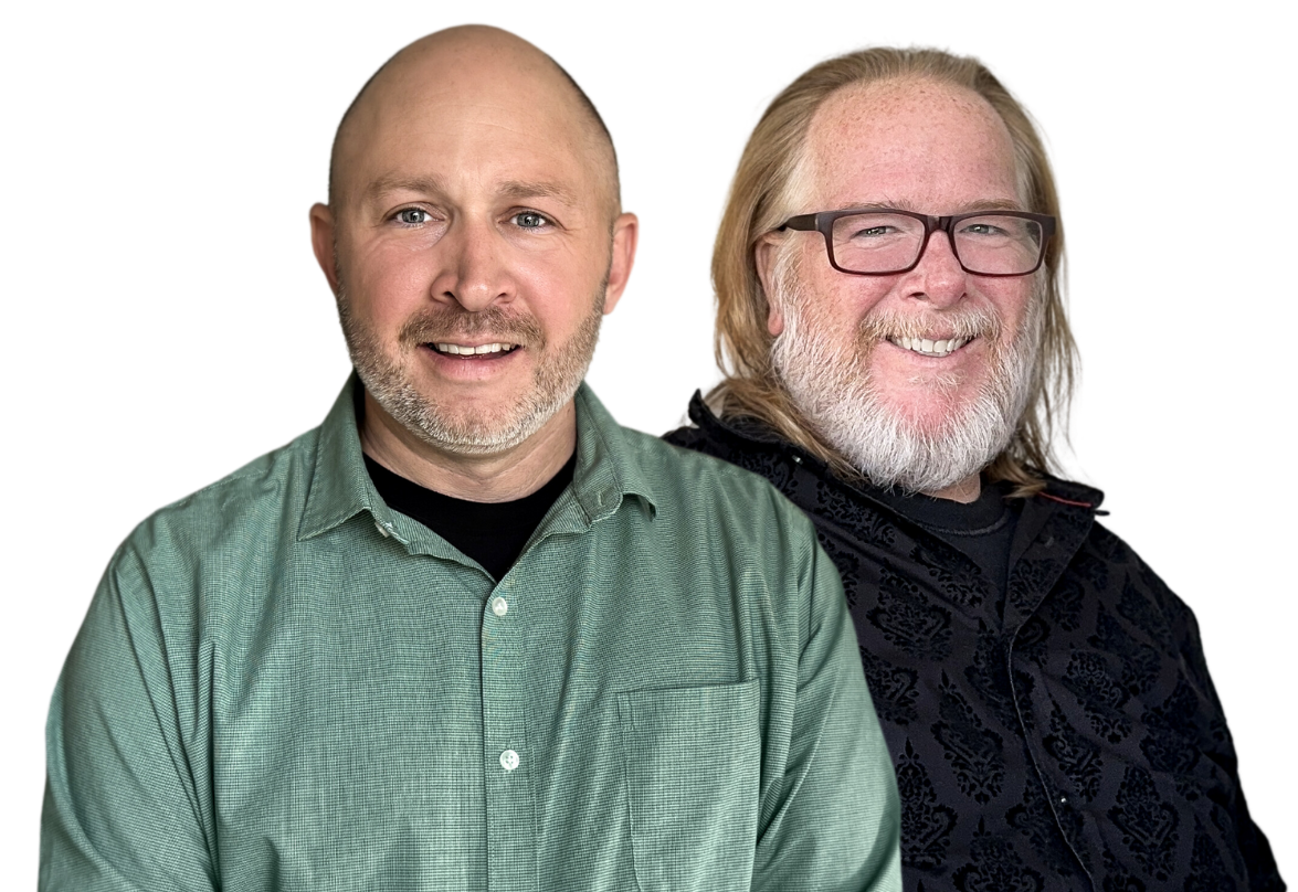 Two men are standing next to each other and smiling for the camera.