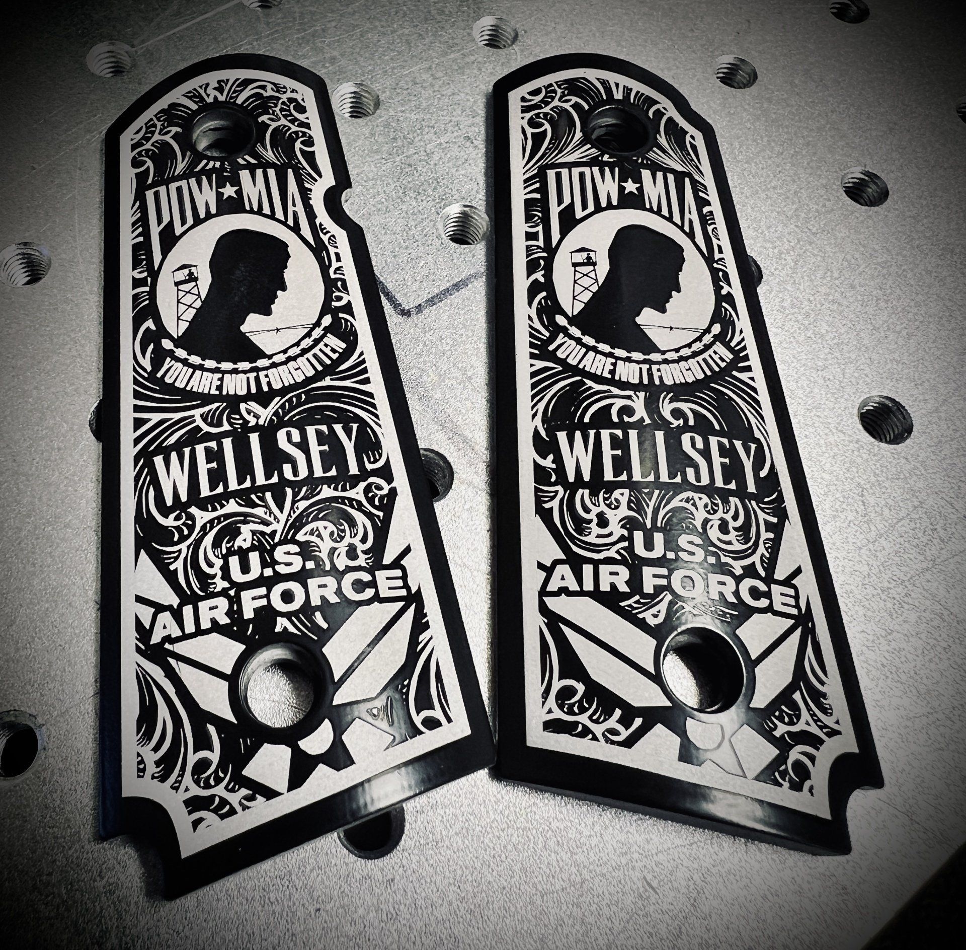 Two black and white custom pistol grips with 
