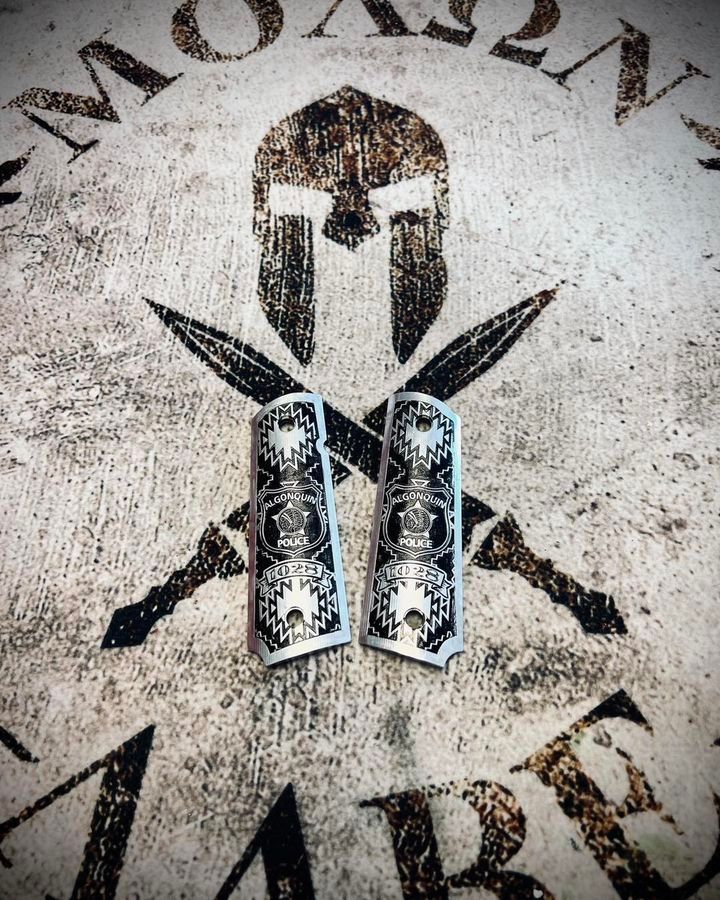 Pair of engraved pistol grips over Spartan helmet, swords, and 