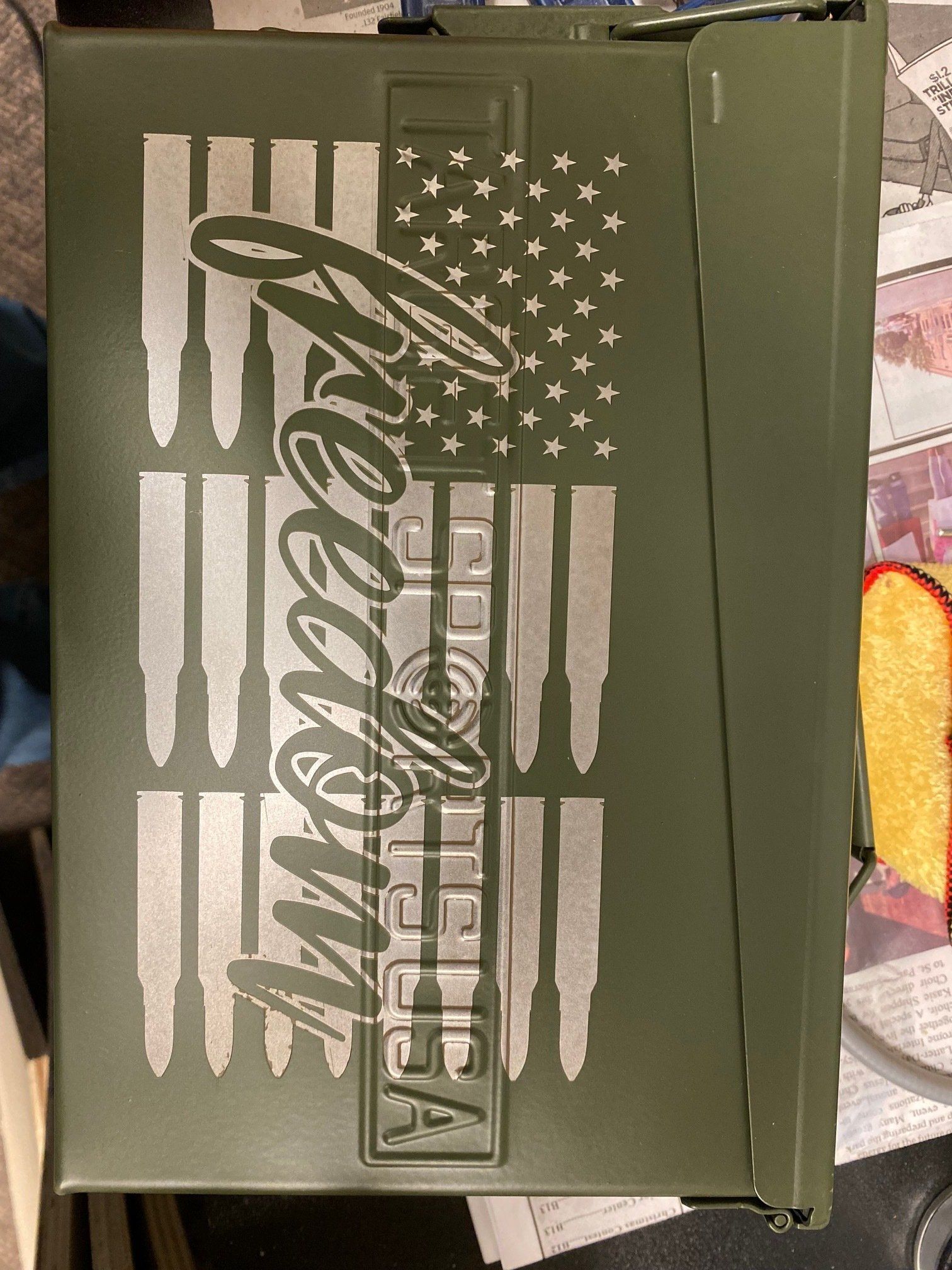 Olive green box with a faded American flag and Coca-Cola logo.