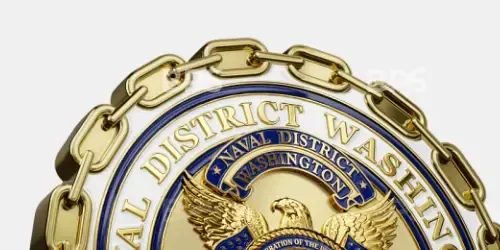 Gold chain framing a circular seal reading “District Attorney” with a blue center