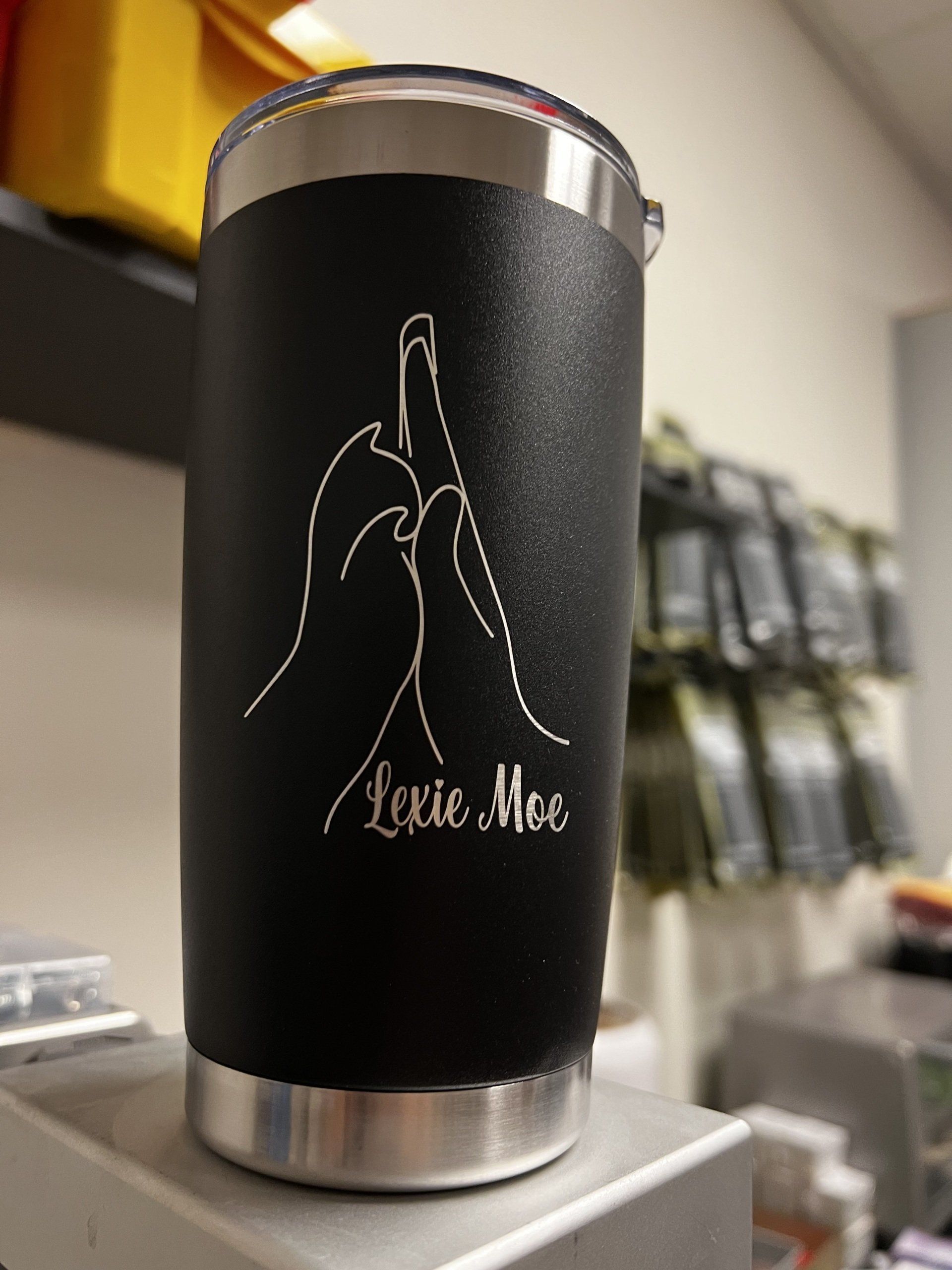 Black insulated tumbler with praying hands and “I like Me” text on a countertop