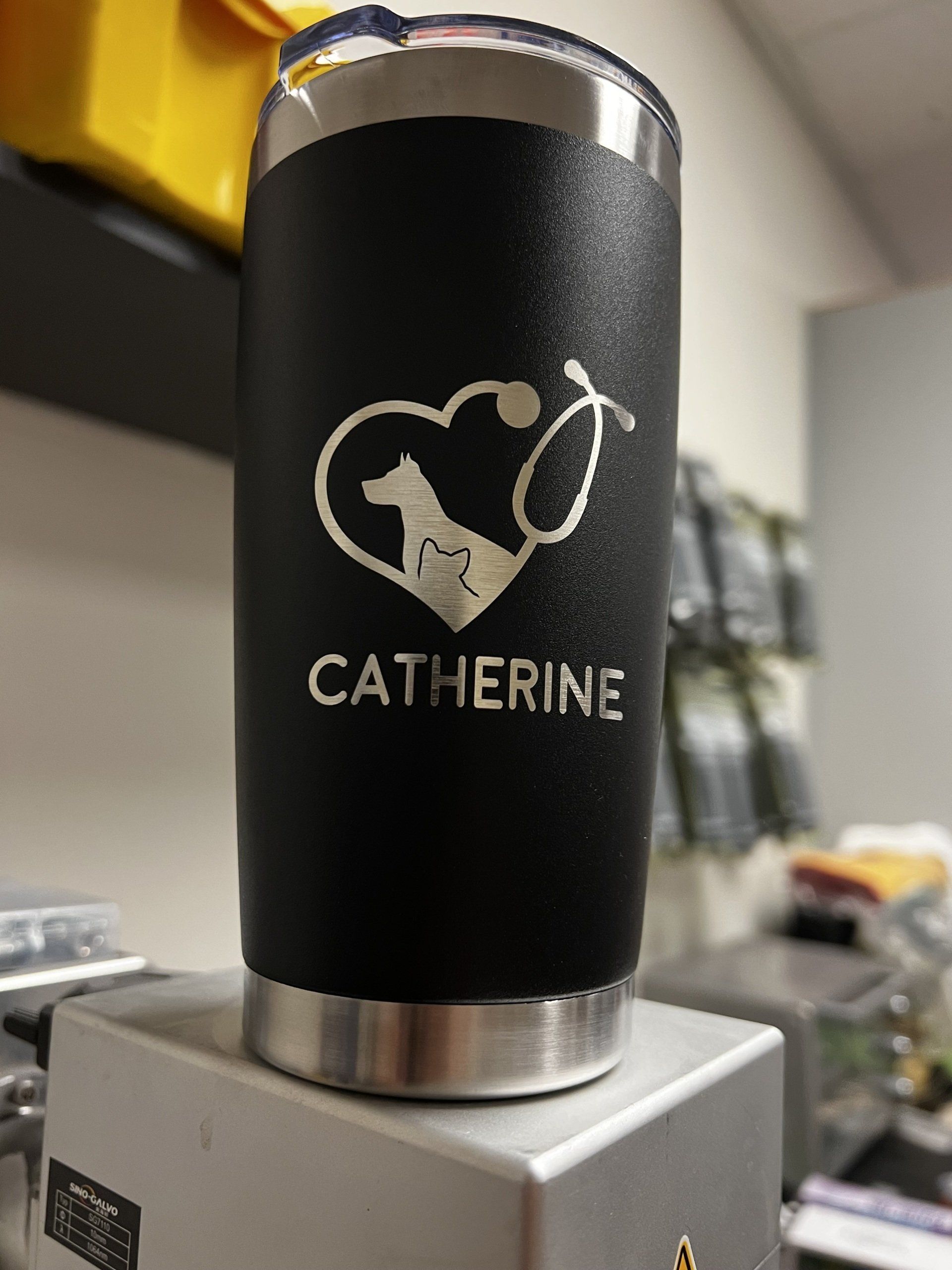 Black insulated tumbler with a cat-and-bubble design and the name “CATHERINE” on a silver base