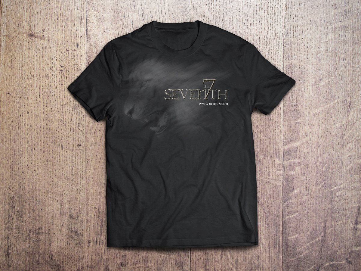 Black graphic T-shirt laid flat on a wood floor background