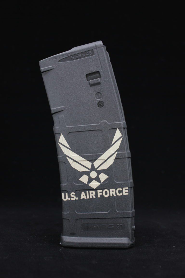 Black U.S. Air Force rifle magazine with winged emblem on a dark background