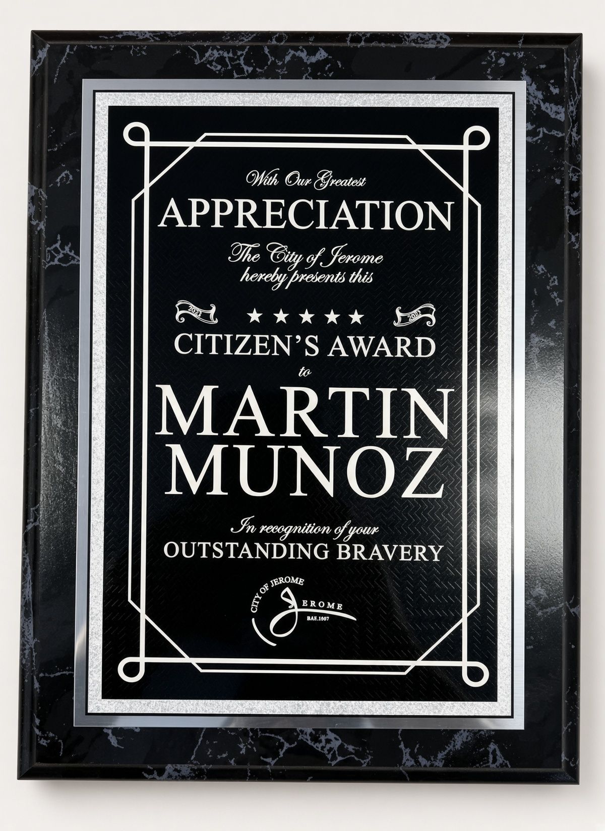 Black plaque reading “Appreciation” and “Citizens Award” for Martin Munoz on a textured wall