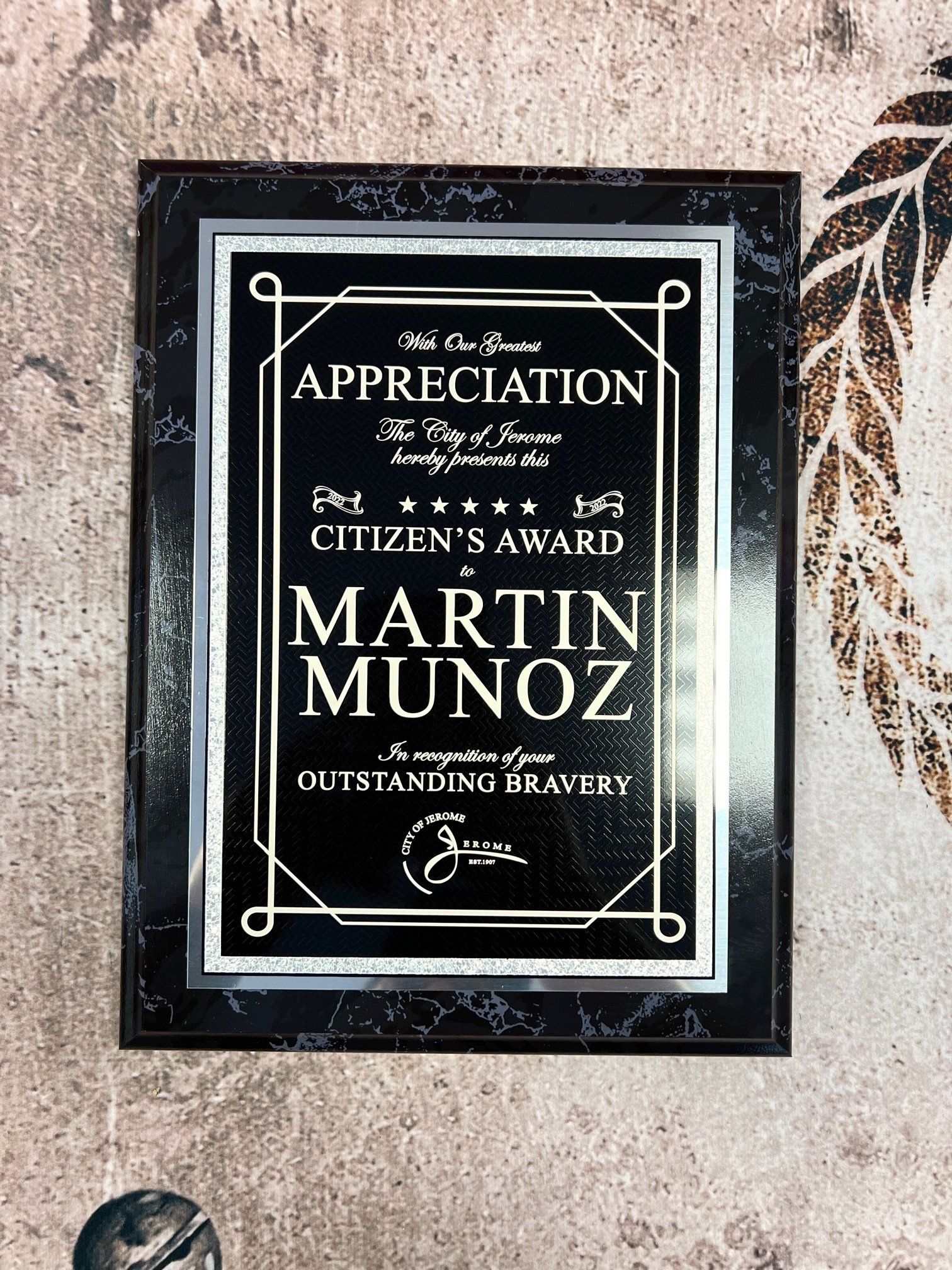 Plaque honoring Martin Munoz with Citizen's Award for Outstanding Bravery. Silver text on a black background.