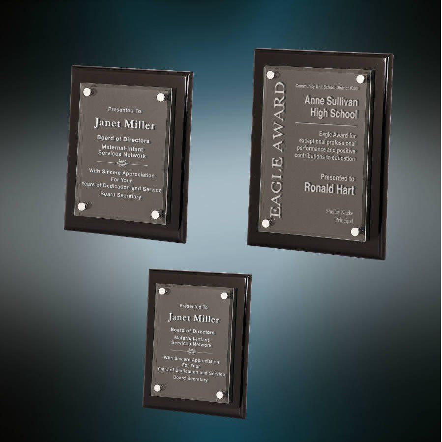Three dark-framed plaques with white text on a teal gradient background.