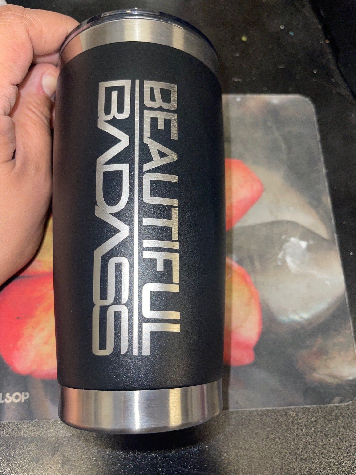 Black cylindrical Beauliful BAGS vape battery held in a hand, with silver ends and white lettering